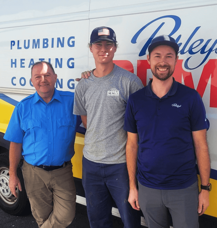 Parley's plumbing and HVAC technicians standing in front of a company van